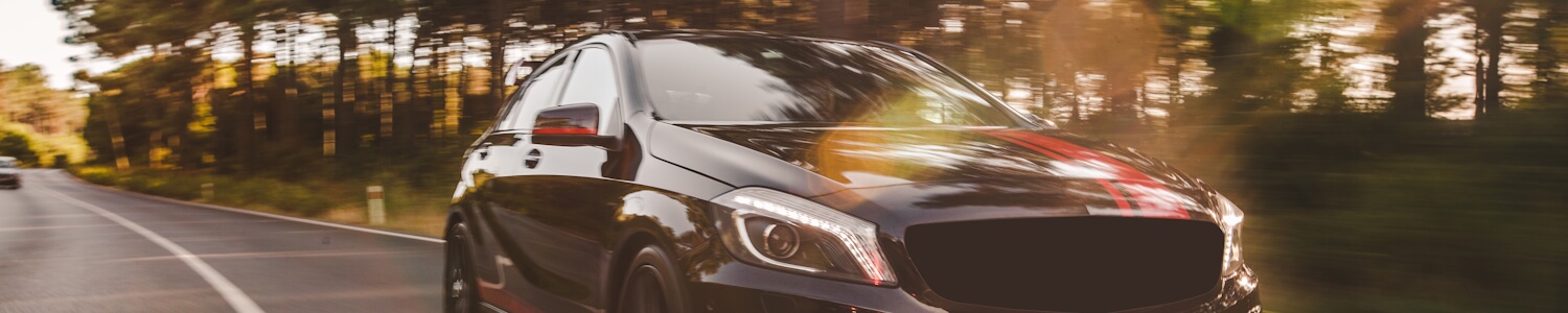 Car driving past neon lights